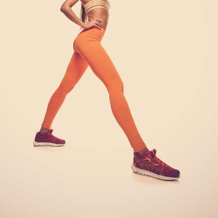 Sporty woman with fit muscular legs stretching, closeup photoの写真素材
