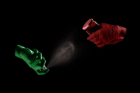 Prevention of virus disease concept. People desinfecting jar with jam on black backgroundの写真素材