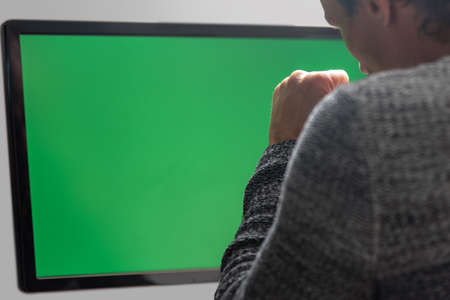 Sad man against green screen having problem with online banking
