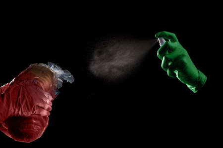 Closeup photo of people applying antiseptic on bread infected with virusの写真素材