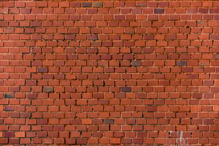 Old vintage red brick wall background, closeup photoの写真素材