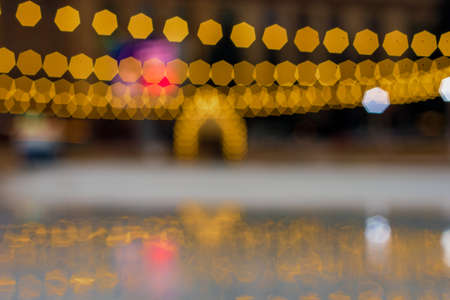 Blurred view of outdoor ice skating rink with christmas decorationの写真素材