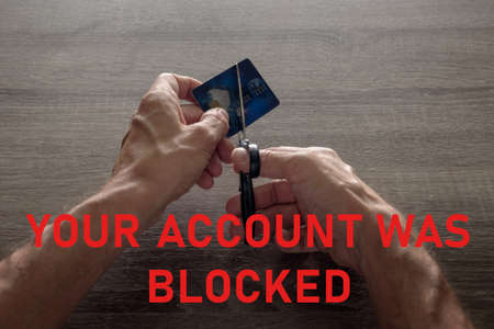 male hands with scissors cut the payment blue master card. concept of liquidation, destruction of...
