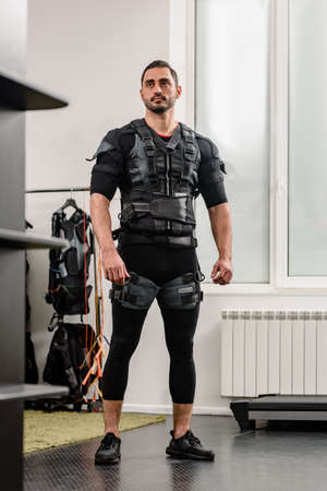 Portrait of young athletic man posing in EMS suitの写真素材