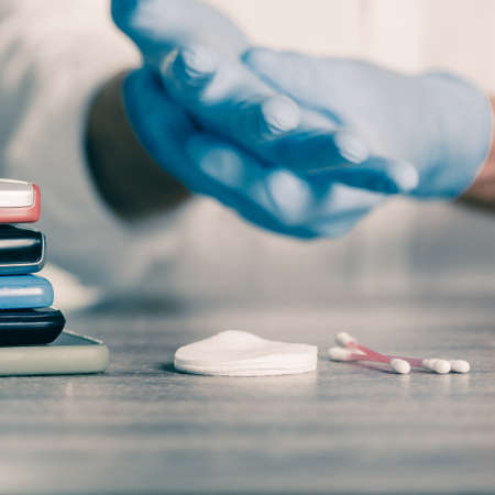 Closeup of man preparing for cleaning mobile phones to protect himself from viruses