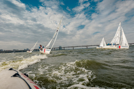 Dnepr, Ukraine- September 09, 2018: summer sport, outdoor socializing, White sailboats floating on blue river water on sunny summer dayのeditorial素材