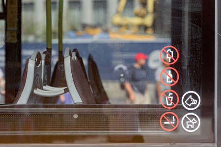 Dnepr, Ukraine- September 12, 2020: Caution and forbidden signs icon on glass in public transport, rules for being in public city transportのeditorial素材