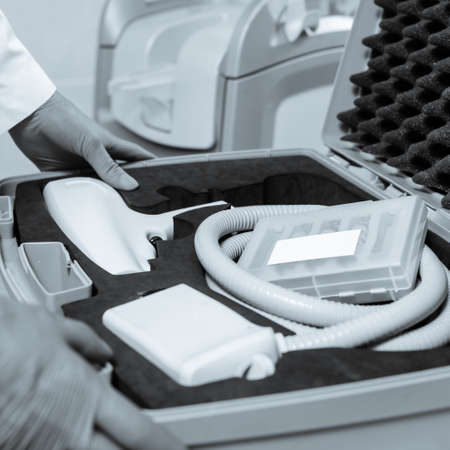 Closeup photo of container with modern medical equipment for thermage procedure. black and white image with blue tint to emphasize the concept of high technologyの写真素材