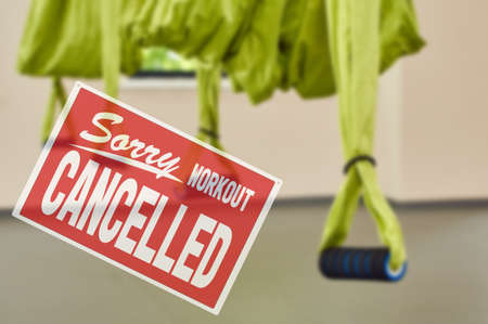 inscription sorry workout canceled. protective measures during a pandemic, closing gyms. fitness club with three hammocks. indoor fitness clubの写真素材