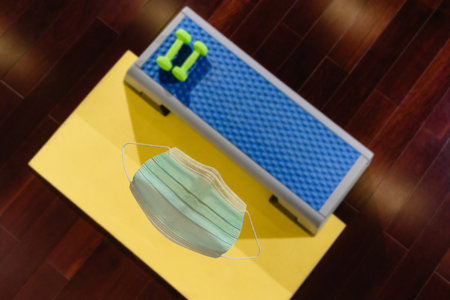 being indoors only in a sanitary mask, Set of fitness accessories: step platform, yoga mat and...