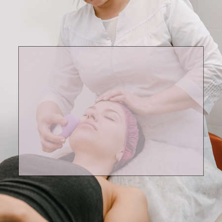 Young woman having ultrasound facial massage in beauty salonの写真素材