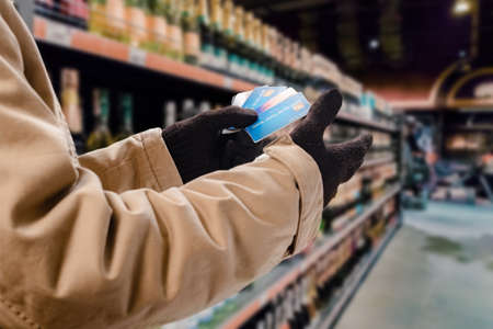 Man doing purchases in grocery shop with credit cardの写真素材