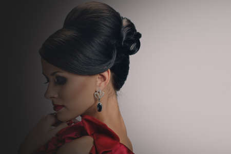 Profile photo of vogue style fashion woman in jewelry, background with a gradient from dark to light