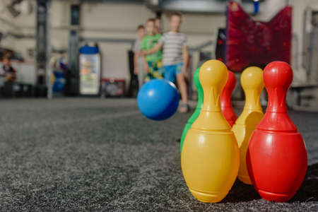 Dnepr, Ukraine- September 06, 2020: Group of excited children playing bowling with colorful skittlesのeditorial素材