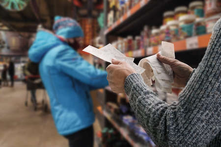 Man in protective mask buying food during pandemicの写真素材