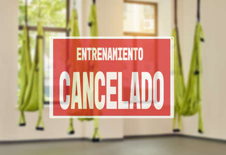 in Spanish inscription sorry workout canceled. protective measures during a pandemic, closing gyms. fitness club with three hammocks. indoor fitness clubの写真素材