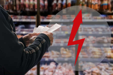 Man thinking how to pay for store bill because of price rising, arrow in the form of a lightning...