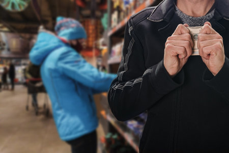Man holding hands over money to protect his cash, safety of personal money savingsの写真素材