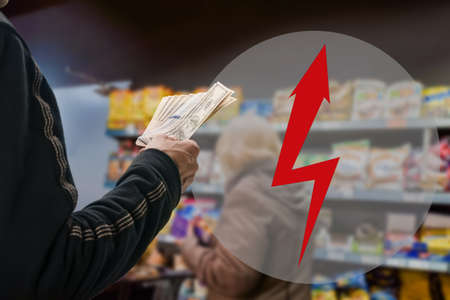 Closeup photo of man holding dollars, cash transactions , money concept of opportunities, benefits, obligations, taxes, arrow lightning hazard symbolの写真素材