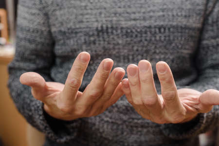 Closeup photo of young man showing hands before manicure, male self-careの写真素材
