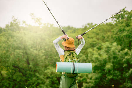 Young teenager traveler with backpack relaxing outdoor with green sunny forest on the backgroundの写真素材
