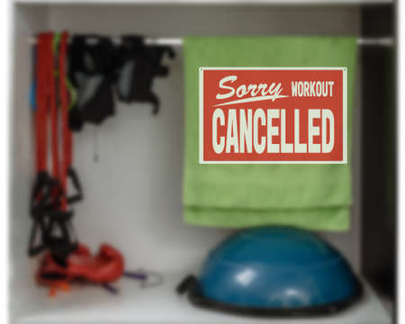 inscription sorry workout canceled. gym restrictions during quarantine. Closeup of shelf with sport inventory in modern fitness centerの写真素材