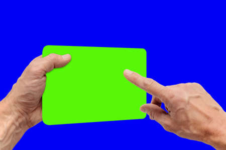 Closeup photo of young man using tablet with chroma key screen, hand of a young man with protruding veins, the device is positioned slightly turnedの写真素材