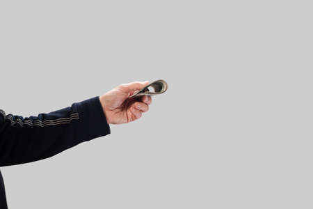 Closeup photo of male hand holding stack of cash money, cash transactions, benefits of purchases, investmentsの写真素材