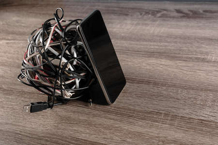 Concept of tangled wires problem solved with wireless technologyの写真素材