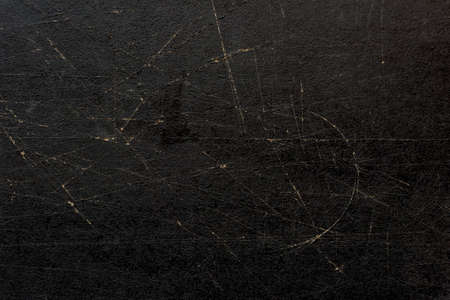 Abstract fragment of an old black wooden door made of pressed shavings