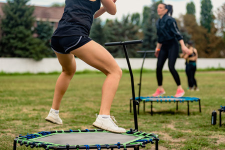 Pavlograd, Ukraine- August 15, 2021: Fit athletic girls jumping on fitness trampolines in public parkのeditorial素材