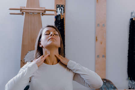 Middle aged attractive fitness woman suffering from pain in neckの写真素材