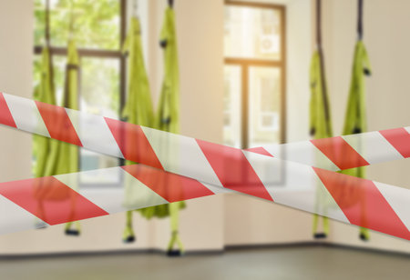 prohibition tapes for gym due to sanitary measures. fitness club with three hammocks. indoor fitness clubの写真素材