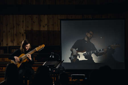 Dnepr, Ukraine- April 15, 2021: Musician giving live online concert with another musician and making online show.のeditorial素材