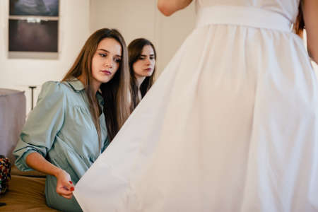 Three women in cafe after shopping discussing new dressの写真素材