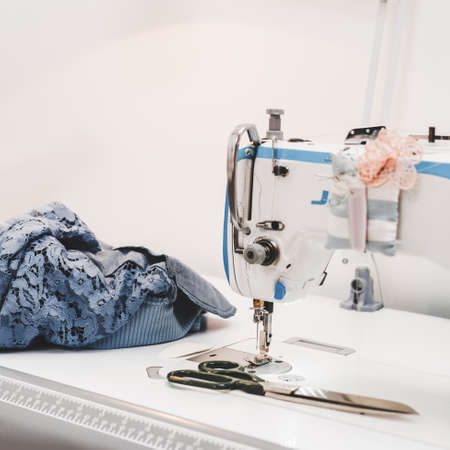 Modern sewing machine on designer work place in modern atelier