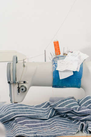 Detailed photo of modern sewing equipment in tailor workshopの写真素材