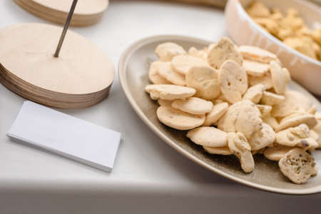 Closeup photo of modern front desk with baking cookies and business cards