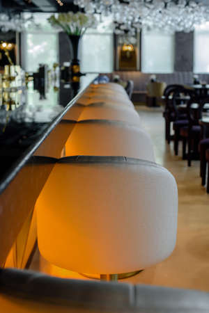 Beautiful empty restaurant interior with leather chairs and bar counterの写真素材