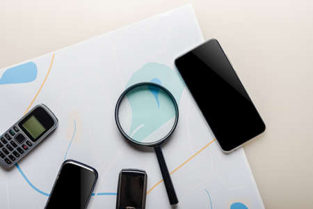 Magnifier, city map and different mobile phones with eavesdropping app for spying