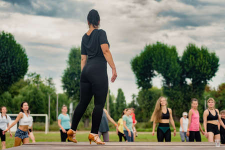 Pavlograd, Ukraine- August 15, 2021: Group of happy dancing women doing aerobics outdoorのeditorial素材