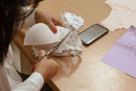 Middle aged female fashion designer creating new collection of outfitの写真素材