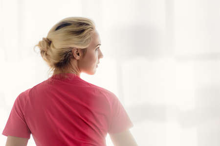 Relaxed fitness blonde woman doing workout at home in daytime