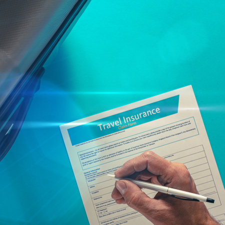 Male hand signing documents for travel insurance on blue backgroundの写真素材