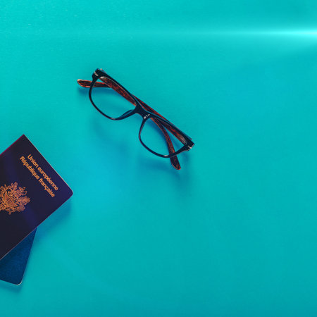 Touristic background with air ticket or boarding pass, french pasports and glassesの写真素材
