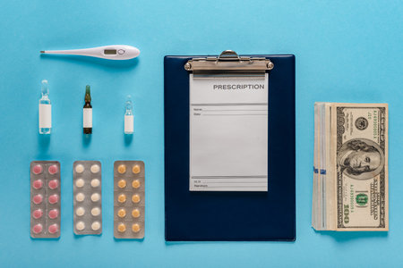 Cash dollars money with prescription, pills, ampoules and thermometer for disease treatmentの写真素材