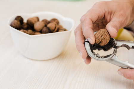 Process of chopping organic walnuts at home with special toolの写真素材