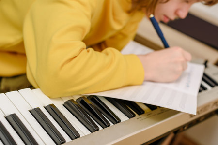 Closeup photo of young concentrated teen amateur songwriter writing song