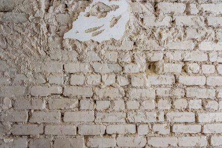 Old destroyed concrete and brick wall with fallen plasterの写真素材