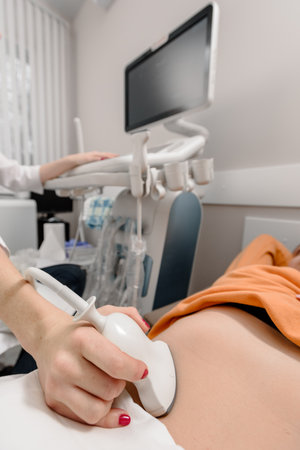 Closeup of professional female doctor doing ultrasound examination for patientの写真素材